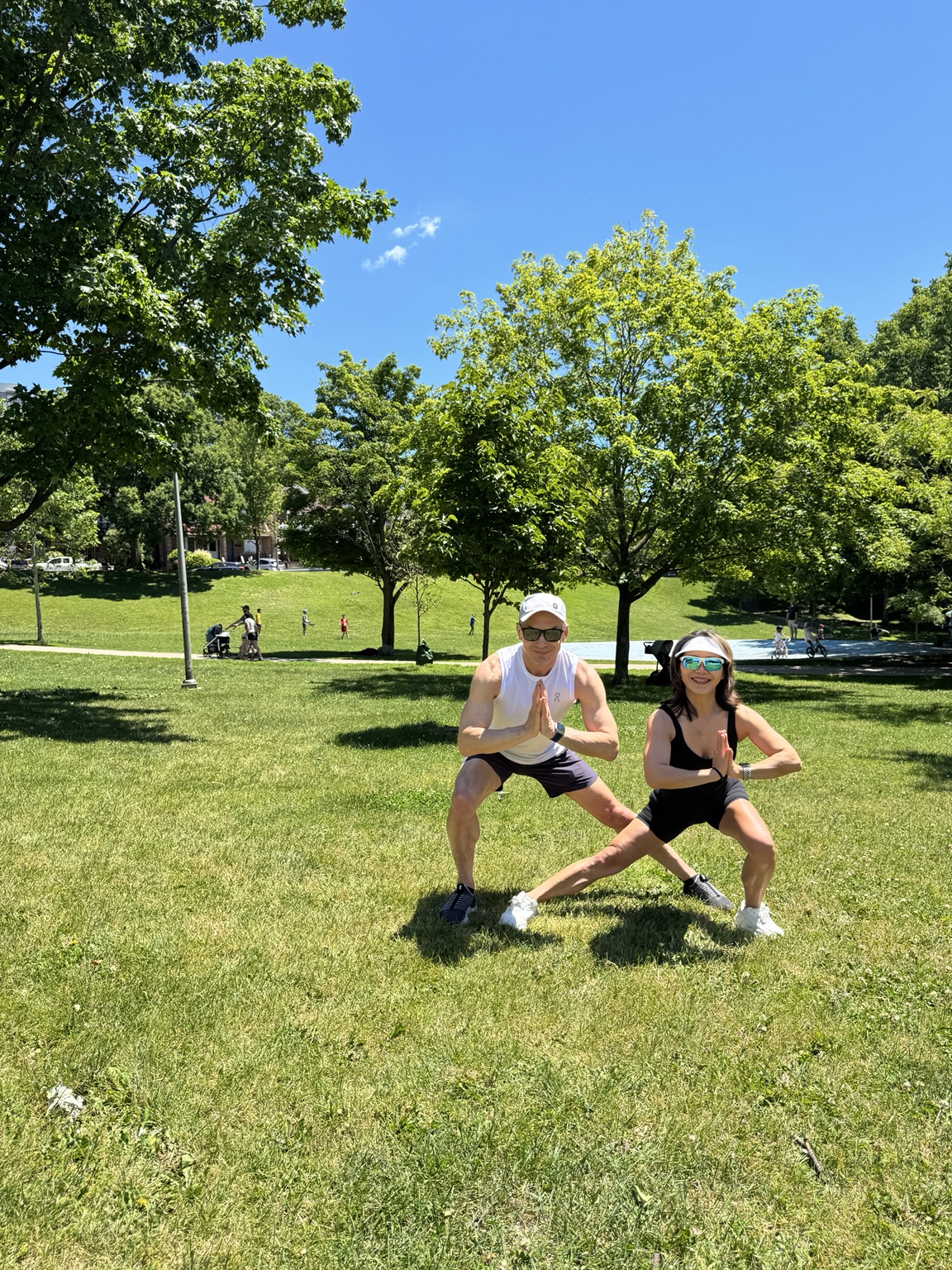 Lili and Igor practicing strong standing poses in High Park